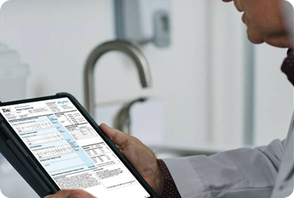 A photo of a person holding a tablet showing a Zio report.